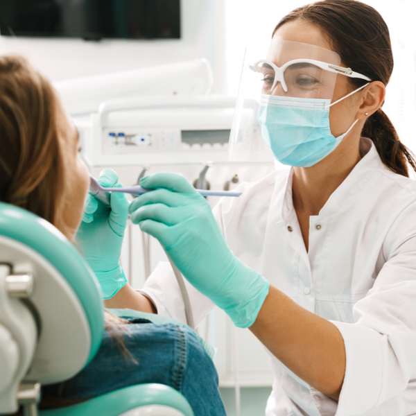 Female orthodontist working on patient